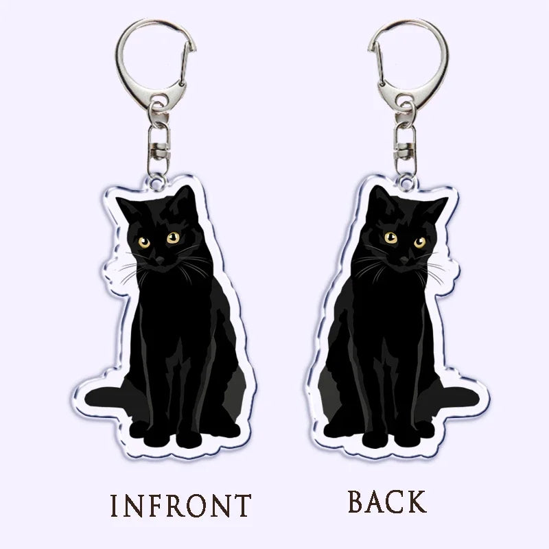 Portachiavi acrilico con gatto nero, coltello e scritta "What is under the cat", perfetto per decorare borse e chiavi.