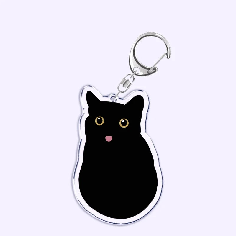 Portachiavi acrilico con gatto nero, coltello e scritta "What is under the cat", perfetto per decorare borse e chiavi.